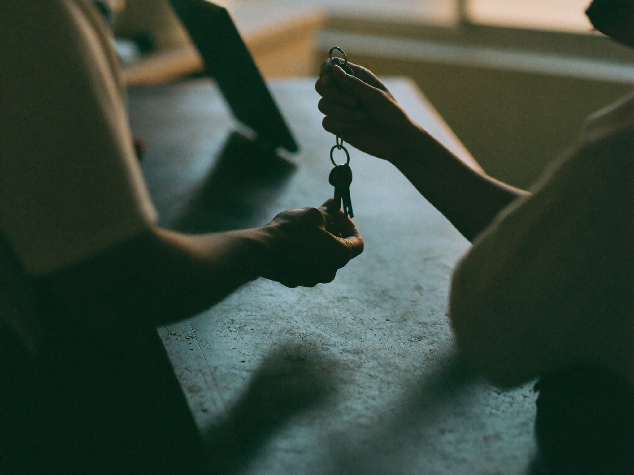 House keys being handed over at a front door
