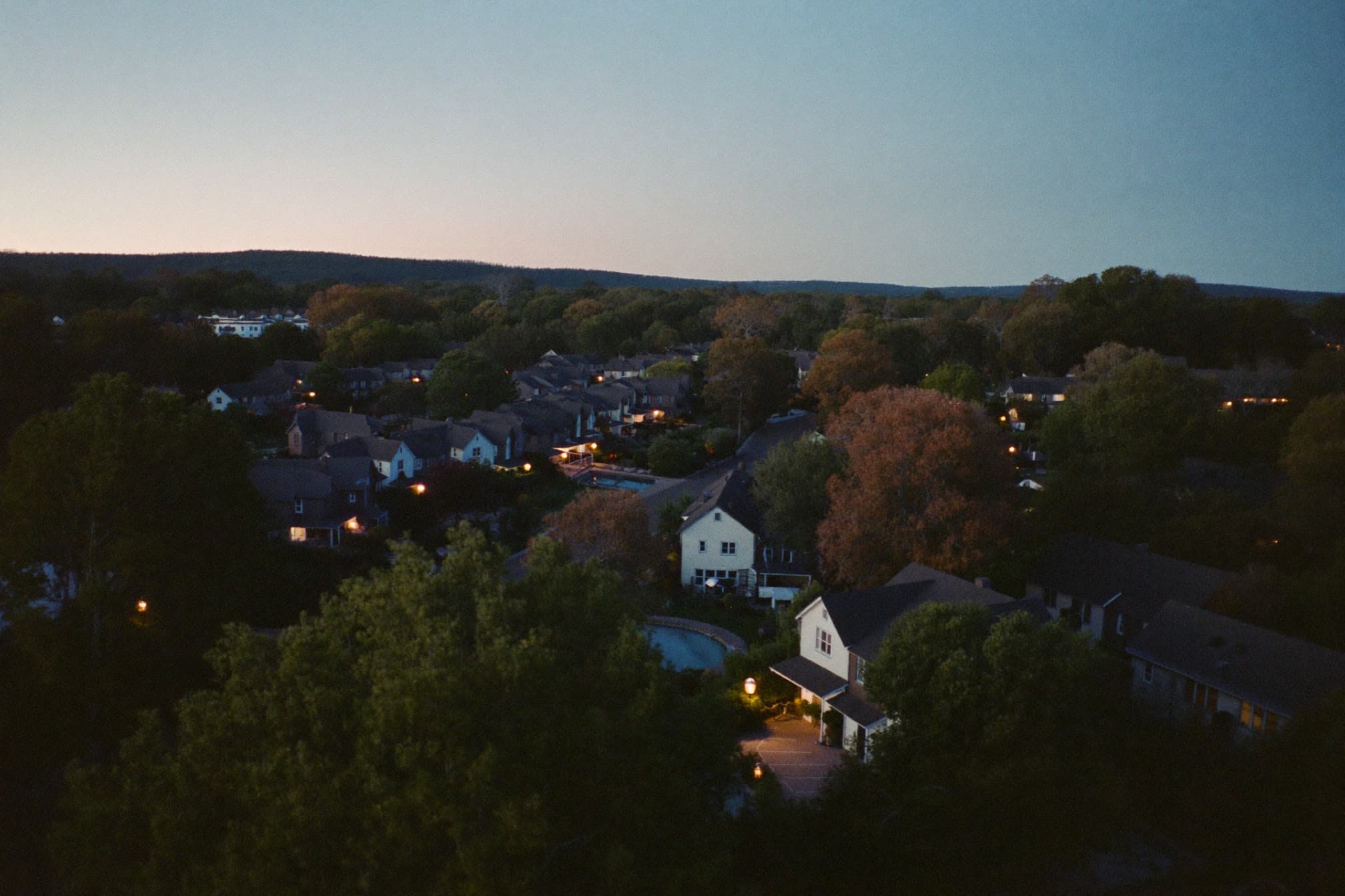 Residential neighborhood rooftops at dusk