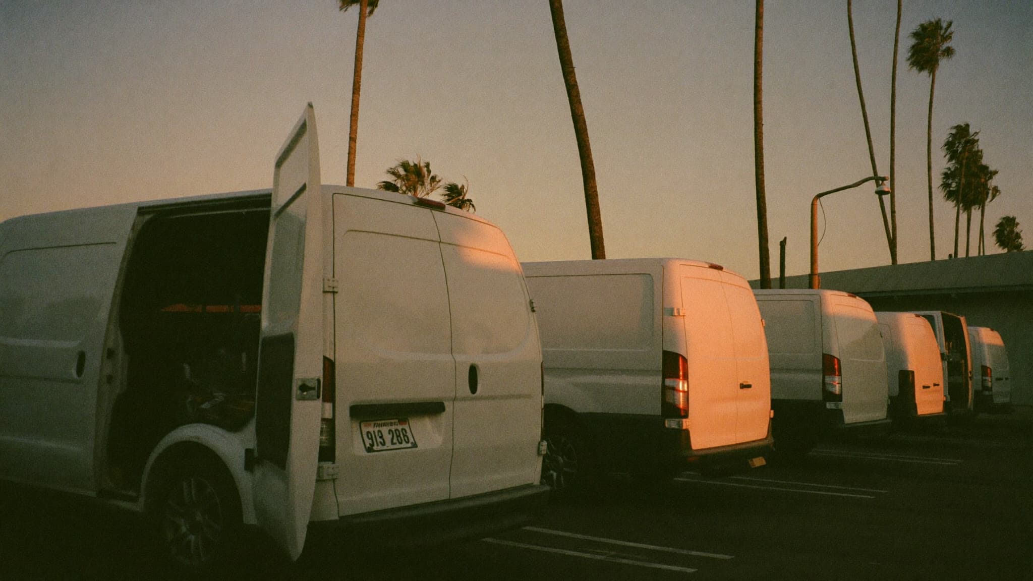 Work vans parked in a lot at dusk